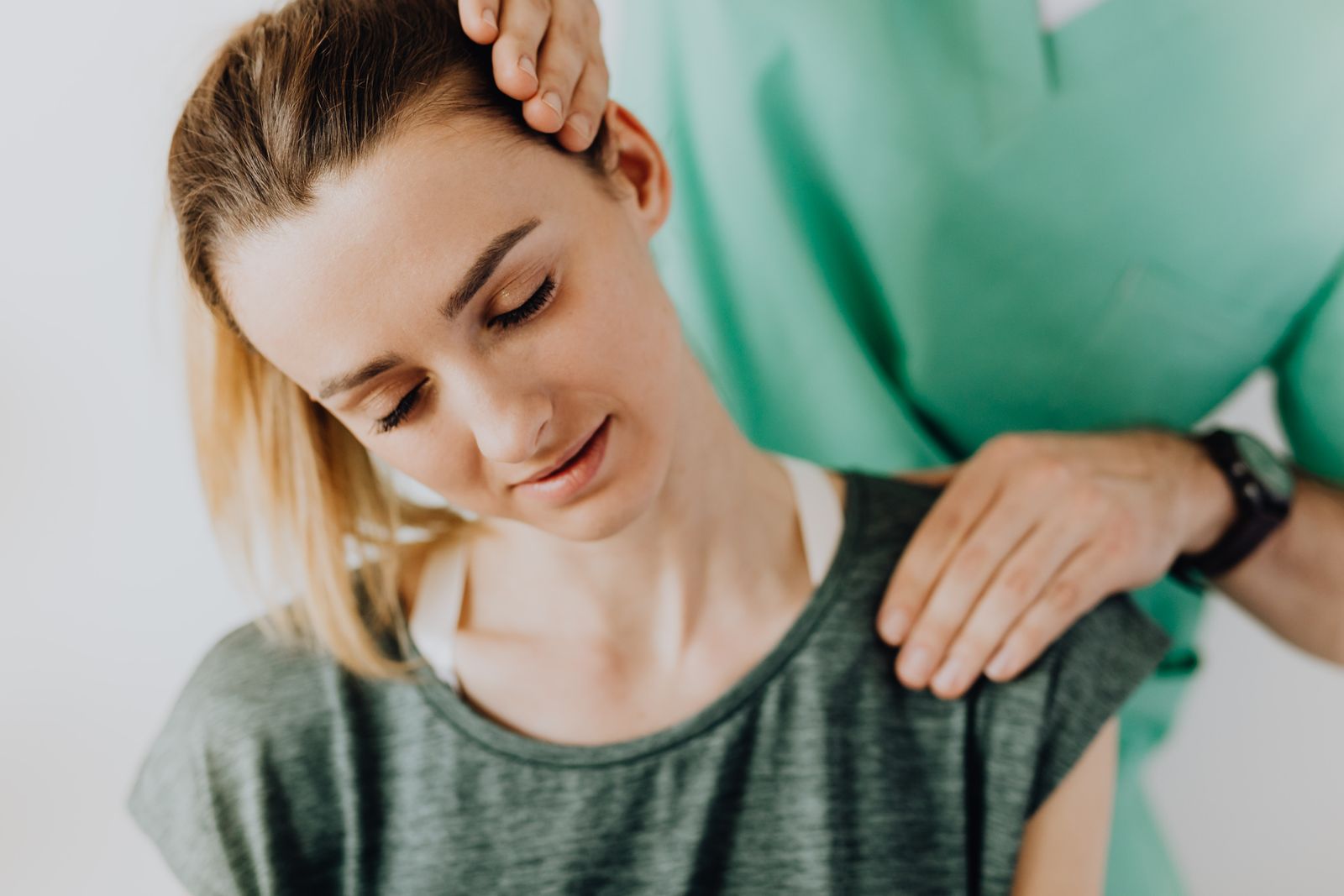 Chiropractor carefully examining a patient's spine during a posture assessment