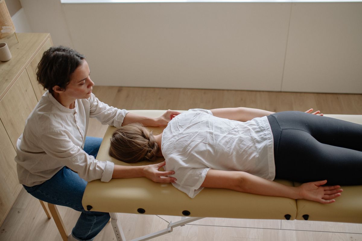 Chiropractor performing a precise spinal adjustment on a patient on a treatment table